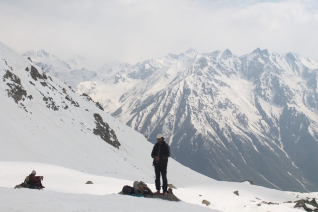 Trekker standing on a boulder at Charang-La glacier
