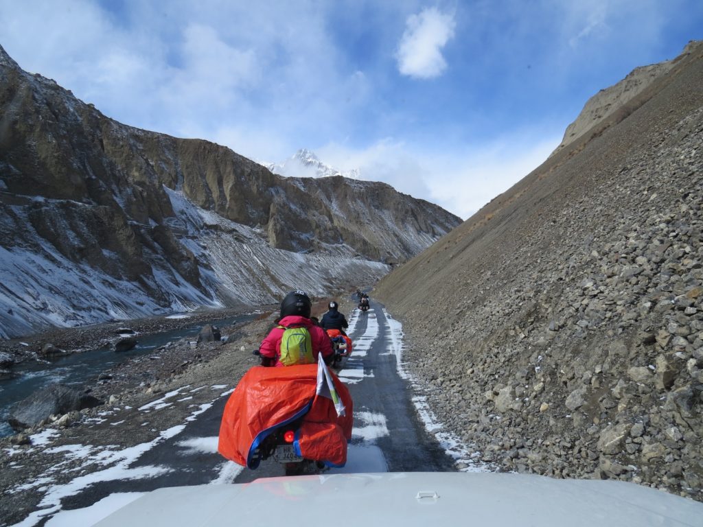 Driving on along the Spiti river on snow covered road
