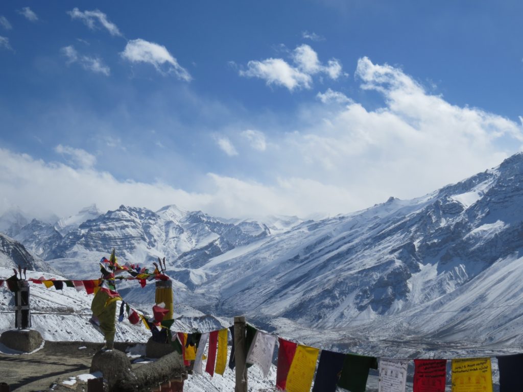 Colorful Buddhist prayer flags adorning the roof of Dhankar monastery